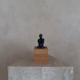 Female Figure on Wooden Plinth